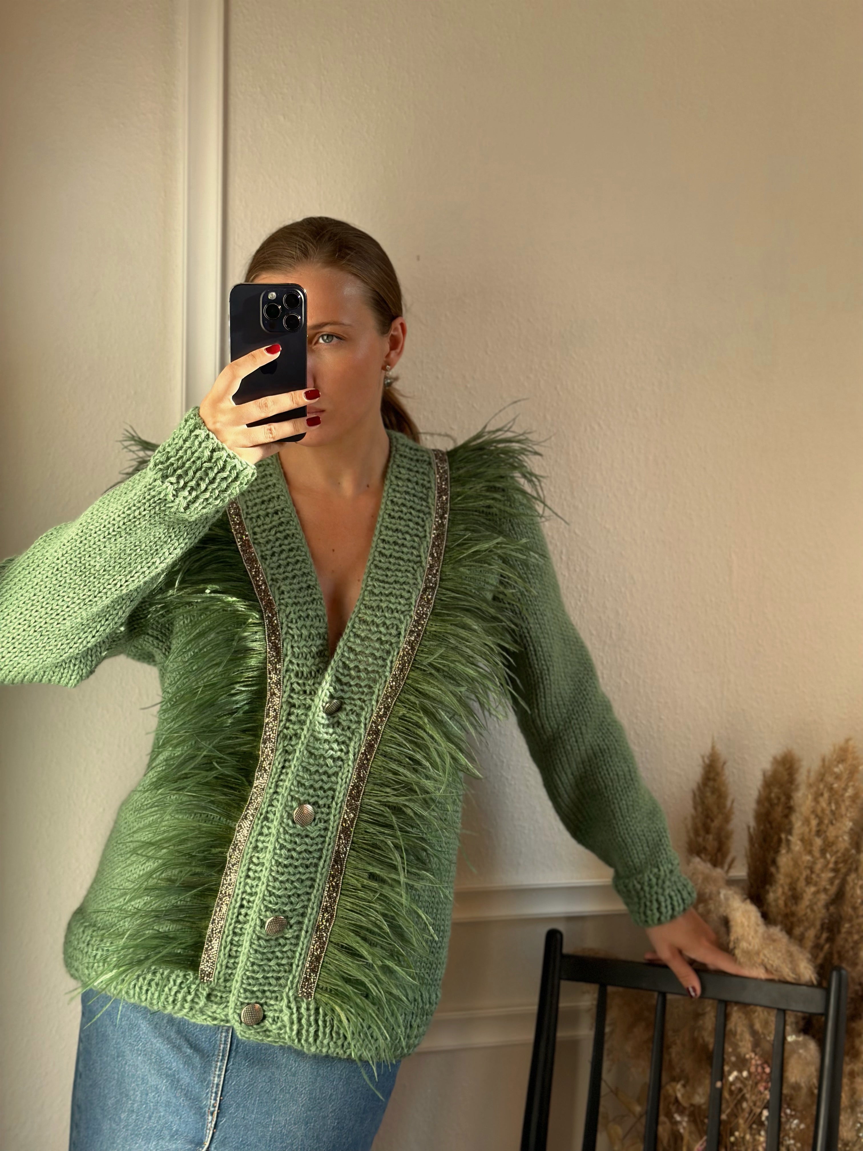 Green cardigan with feathers