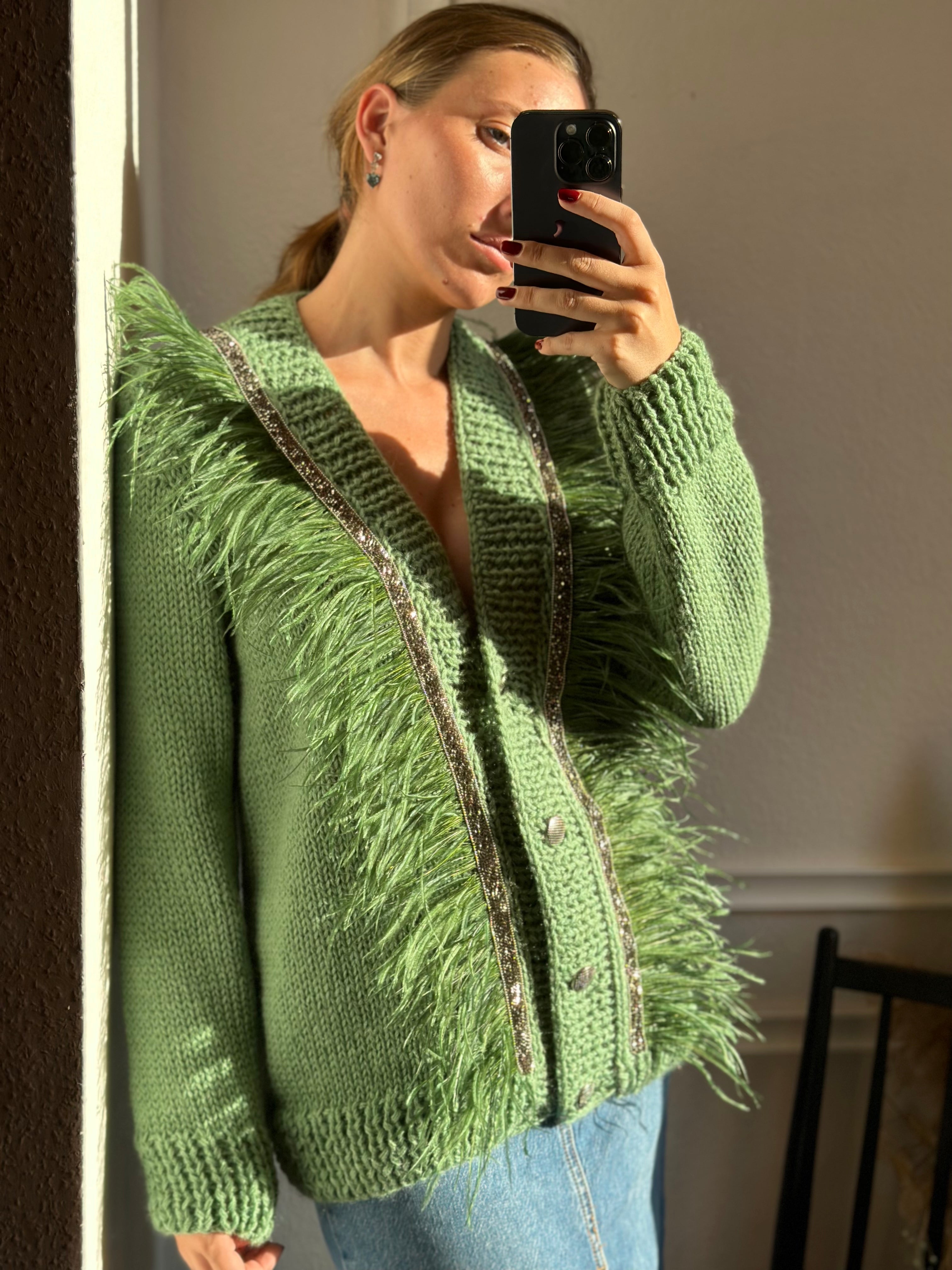 Green cardigan with feathers