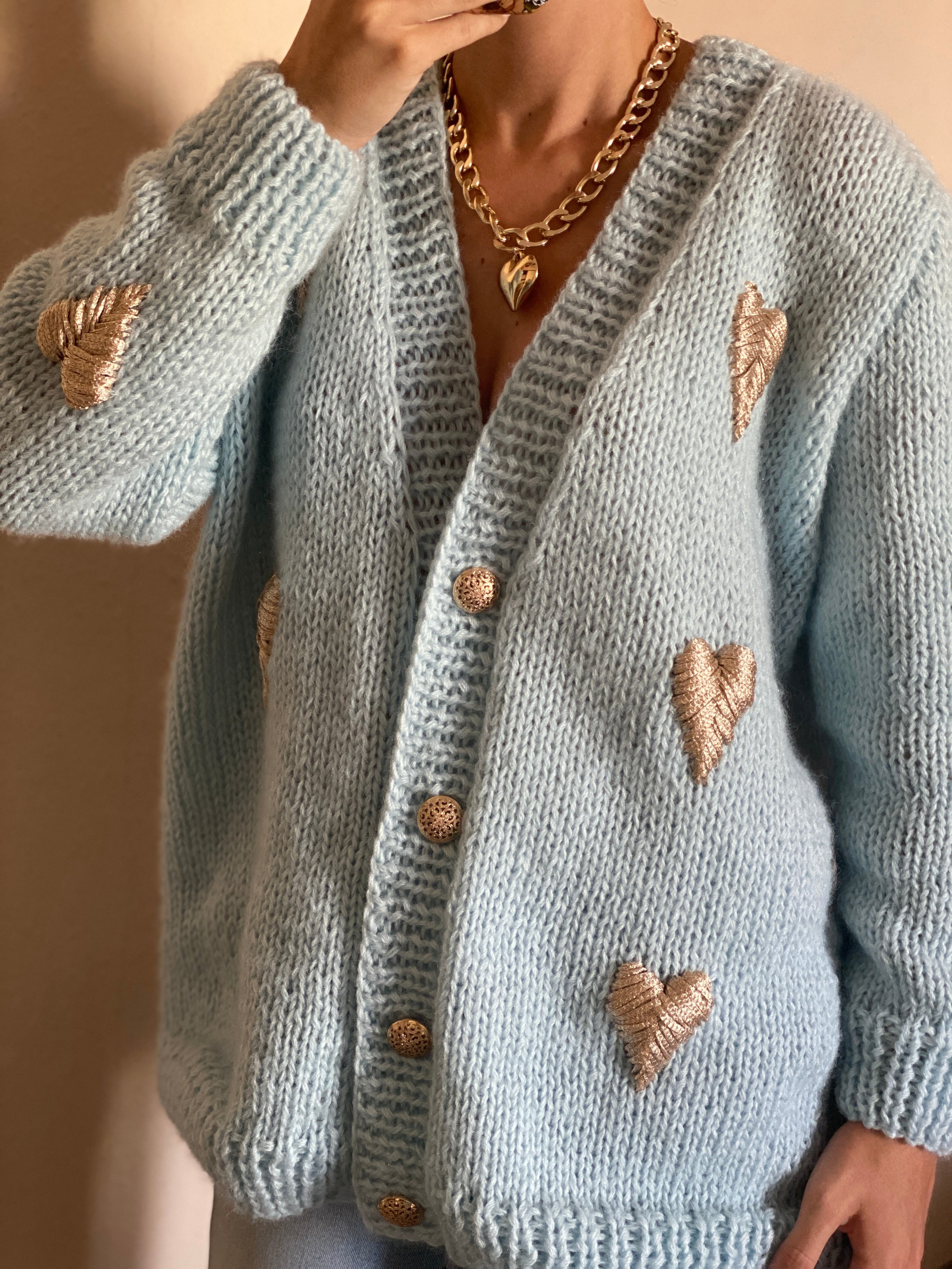 Blue cardigan with golden hearts