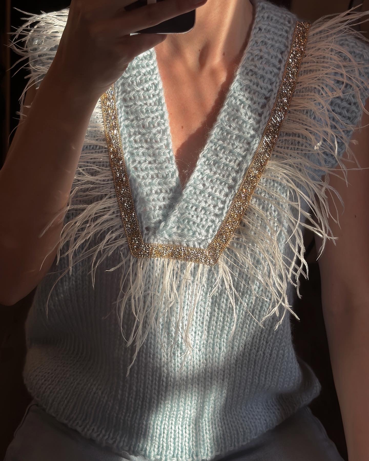 Brown vest with feathers