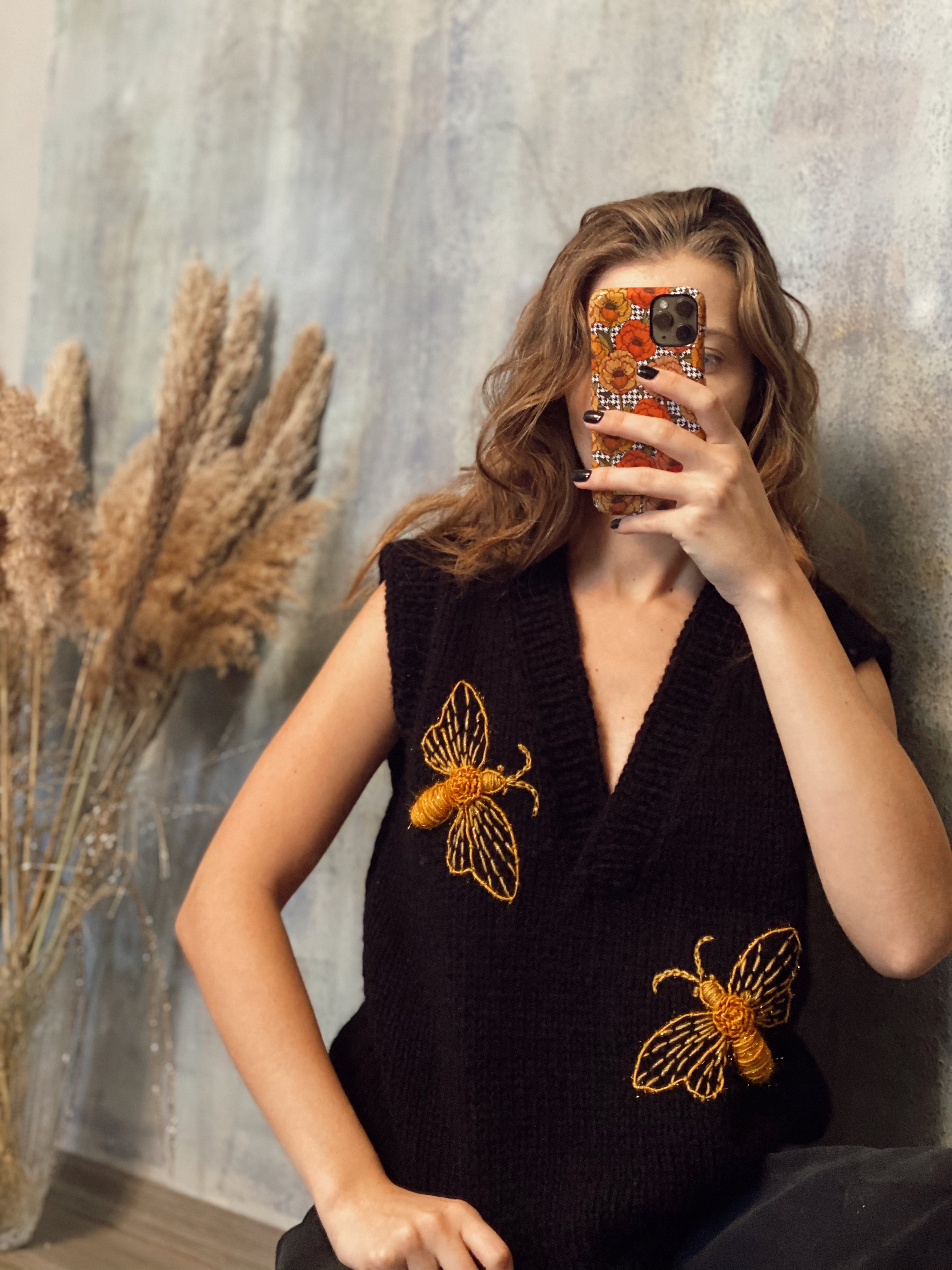 Black sleeveless vest with bees