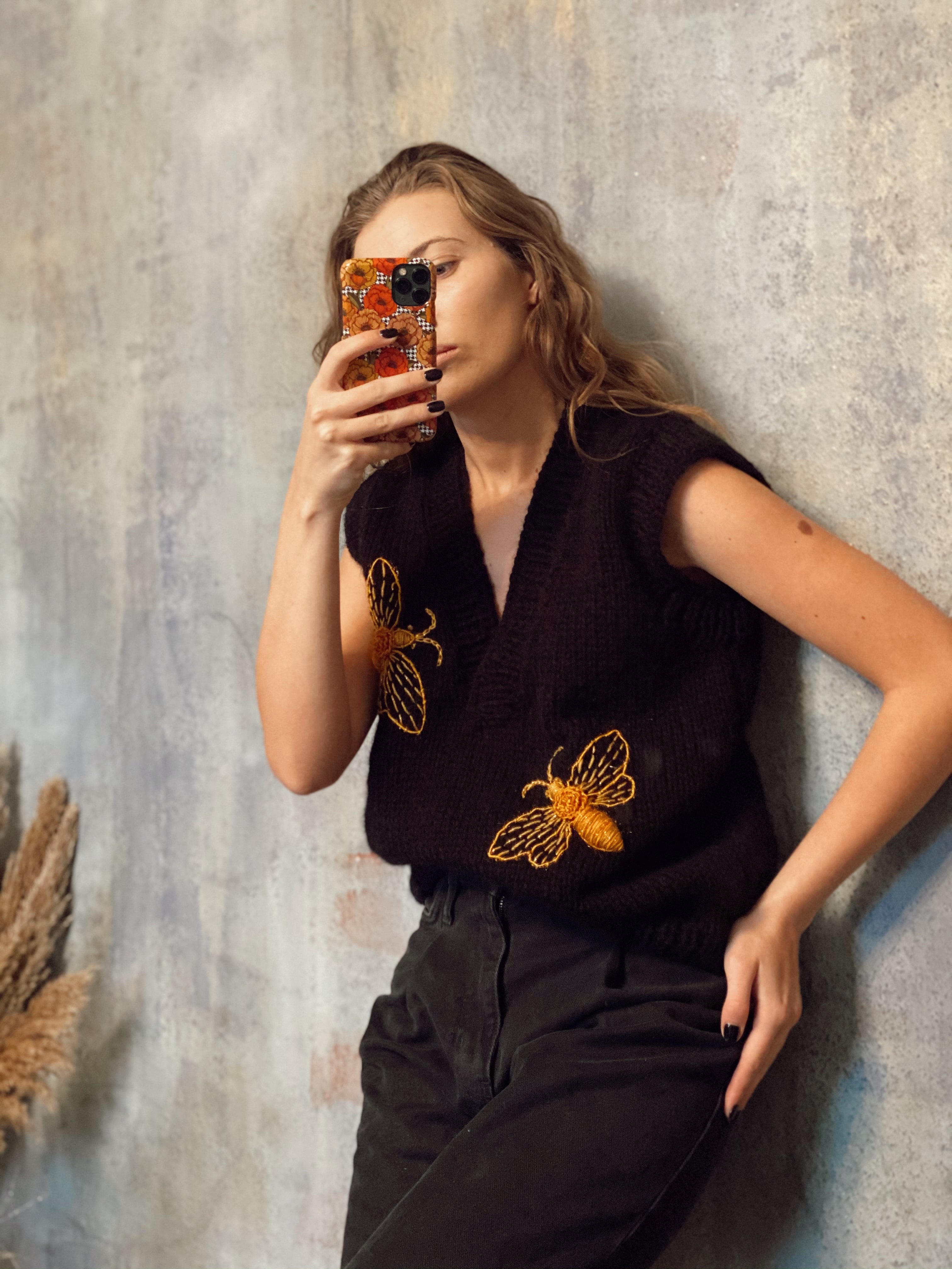 Black sleeveless vest with bees
