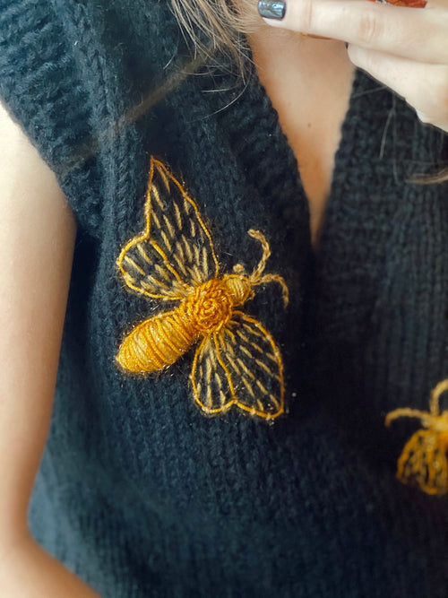 Black sleeveless vest with bees